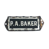 P.A. Baker, Silver Foil and Reverse Painted Glass Nameplate with Scalloped Edge