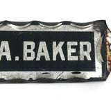 P.A. Baker, Silver Foil and Reverse Painted Glass Nameplate with Scalloped Edge