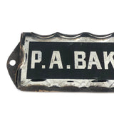 P.A. Baker, Silver Foil and Reverse Painted Glass Nameplate with Scalloped Edge