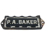 P.A. Baker, Silver Foil and Reverse Painted Glass Nameplate with Scalloped Edge