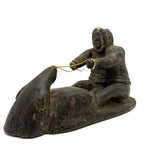 Striking and Sensitive Inuit Stone Carving of Man and Seal with Sinew Reins (Shoulder Repair)