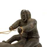 Striking and Sensitive Inuit Stone Carving of Man and Seal with Sinew Reins (Shoulder Repair)