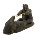 Striking and Sensitive Inuit Stone Carving of Man and Seal with Sinew Reins (Shoulder Repair)