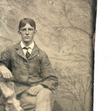 Melancholic Looking Young Man Against Whispy, Moody Painted Backdrop