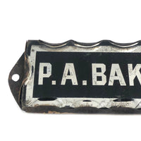 P.A. Baker, Silver Foil and Reverse Painted Glass Nameplate with Scalloped Edge