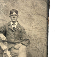 Melancholic Looking Young Man Against Whispy, Moody Painted Backdrop