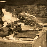 Dramatic Photo of Man at Work on Wings in Barn, with Hanging Geese and Flock of Sheep