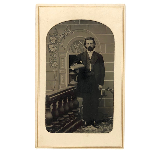 Stern Man with Bible Against Absurd Backdrop, Antique Tintype Portrait