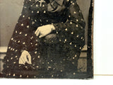Mystical Looking Young Woman in Black Dress with Cross, Curls, and Heart-like Butterflies