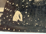 Mystical Looking Young Woman in Black Dress with Cross, Curls, and Heart-like Butterflies