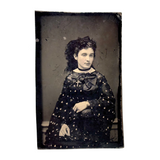 Mystical Looking Young Woman in Black Dress with Cross, Curls, and Heart-like Butterflies
