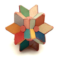 Many Faceted Hand-sewn Cloth over Board Star in Ice Cream Colors with Rattle Inside