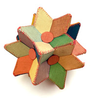 Many Faceted Hand-sewn Cloth over Board Star in Ice Cream Colors with Rattle Inside