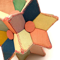 Many Faceted Hand-sewn Cloth over Board Star in Ice Cream Colors with Rattle Inside
