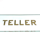 TELLER, Perfectly Precise (and Concise) Thick Glass Sign with Gold Lettering