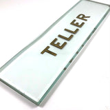 TELLER, Perfectly Precise (and Concise) Thick Glass Sign with Gold Lettering