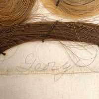 Annotated Collected Hair Locks Stitched to Paper with Handwritten Names #2 (Ginger George and Little George), 1860s
