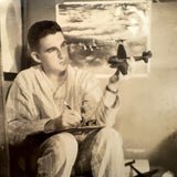 Dreamy Young Man in Pajamas with Airplanes
