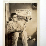 Dreamy Young Man in Pajamas with Airplanes