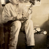 Dreamy Young Man in Pajamas with Airplanes