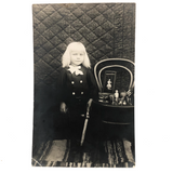 Otherworldly Looking Child with Sword, Toys, and Fantastic Quilted Backdrop