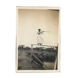 Woman on High Pointing Rifle, Old Snapshot Photo