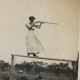 Woman on High Pointing Rifle, Old Snapshot Photo