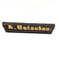 A Botschan Reverse Painted Glass Name Plate with Gold Foil Letters