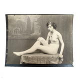 Nude Staring Back,  Loaded Antique Photograph of Model on Table with Wrinkled Fabric and Painted Backdrop