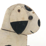 Old Black and Spotted Wooden Dog on Wheel