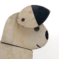 Old Black and Spotted Wooden Dog on Wheel