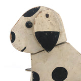 Old Black and Spotted Wooden Dog on Wheel