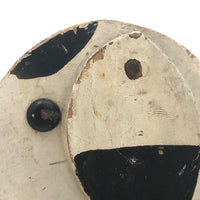 Old Black and Spotted Wooden Dog on Wheel