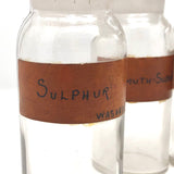 Glass Apothecary Bottles with Handwritten Labels from Houle's Pharmacy, Lowell, MA