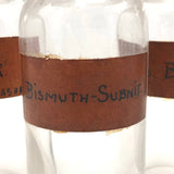 Glass Apothecary Bottles with Handwritten Labels from Houle's Pharmacy, Lowell, MA