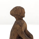 Old Carved Seated Figure on Stump
