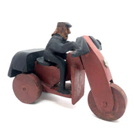 Hard-carved Man in Black with Mullet on (Three-wheeled) Motorcycle