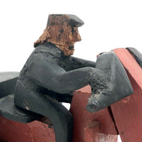 Hard-carved Man in Black with Mullet on (Three-wheeled) Motorcycle