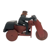 Hard-carved Man in Black with Mullet on (Three-wheeled) Motorcycle