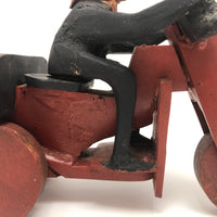 Hard-carved Man in Black with Mullet on (Three-wheeled) Motorcycle