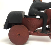 Hard-carved Man in Black with Mullet on (Three-wheeled) Motorcycle