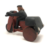 Hard-carved Man in Black with Mullet on (Three-wheeled) Motorcycle