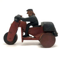 Hard-carved Man in Black with Mullet on (Three-wheeled) Motorcycle