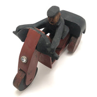 Hard-carved Man in Black with Mullet on (Three-wheeled) Motorcycle
