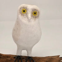 White Folk Art Owl with Bright Yellow Eyes on Driftwood