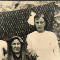 Striking Antique RPPC Family Portrait in Front of Woven Textile