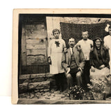 Striking Antique RPPC Family Portrait in Front of Woven Textile