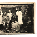 Striking Antique RPPC Family Portrait in Front of Woven Textile