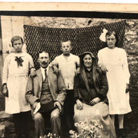 Striking Antique RPPC Family Portrait in Front of Woven Textile