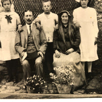 Striking Antique RPPC Family Portrait in Front of Woven Textile